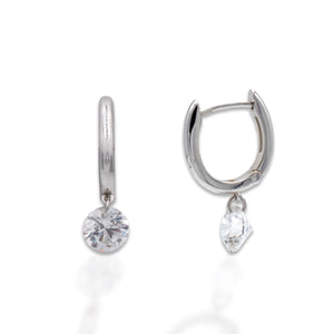 The Kelly Herd Clear Stone Naked Earrings feature two 1CT clear cubic zirconia stones, that free float on the sterling silver hoops. These earrings are sure to catch everyone's eye as they shimmer in the light. These earrings are the perfect compliment to our Clear Stone Naked Pendant. When worn together they make for a truly stunning ensemble.    Features      1 CT Clear Cubic Zirconia     Free Floating Stone     Matching Pendant Available     Available in Sterling Silver